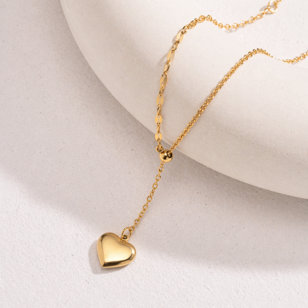 A gold-plated stainless steel chain for women featuring a Y-shaped lariat design with a polished 3D puffed heart pendant