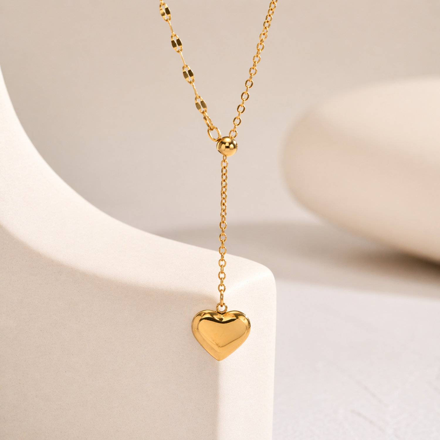 A gold-plated stainless steel chain for women featuring a Y-shaped lariat design with a polished 3D puffed heart pendant
