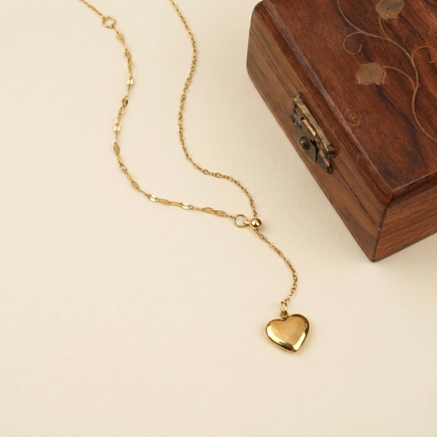 A gold-plated stainless steel chain for women featuring a Y-shaped lariat design with a polished 3D puffed heart pendant