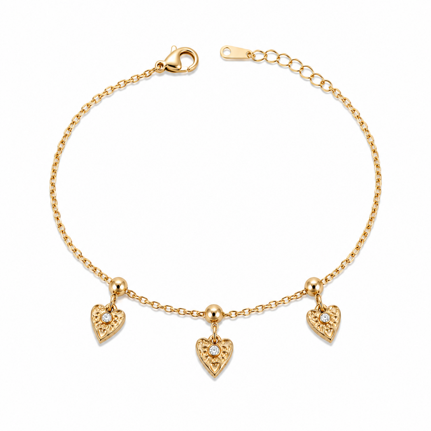A gold-plated ladies bracelet with a fine chain featuring three dangling filigree-engraved hearts and sparkling crystal centers.