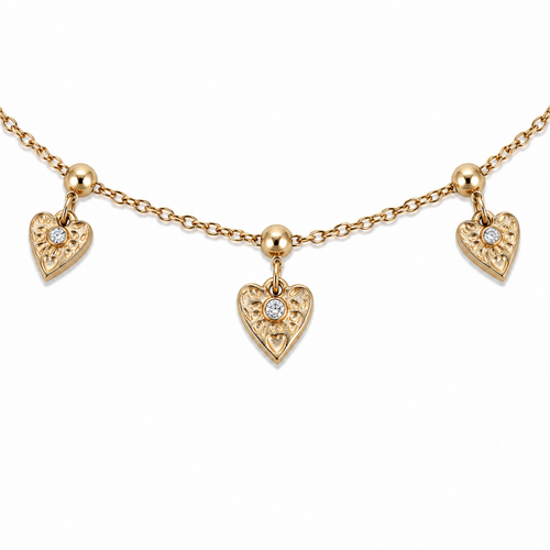 A close-view of a gold-plated ladies bracelet with a fine chain featuring three dangling filigree-engraved hearts and sparkling crystal centers.