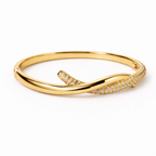 A side-view of a gold-plated twisted hinge bangle for women featuring a continuous row of sparkling white stones on a white background