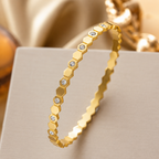 A gold-plated hexagonal bangle for women featuring inlaid brilliant crystals and a secure side-hinge clasp.