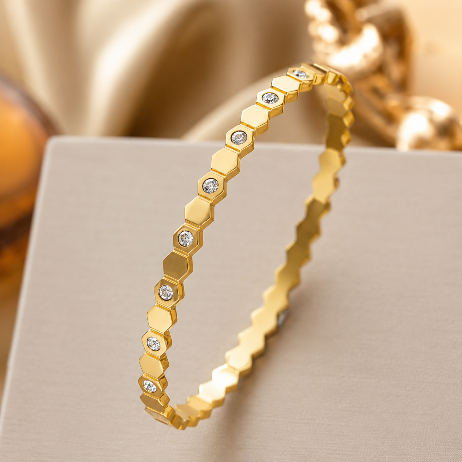 A gold-plated hexagonal bangle for women featuring inlaid brilliant crystals and a secure side-hinge clasp.