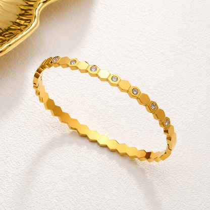 A gold-plated hexagonal bangle for women featuring inlaid brilliant crystals and a secure side-hinge clasp