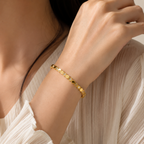 A gold-plated hexagonal bangle for women featuring inlaid brilliant crystals and a secure side-hinge clasp, shown on a model