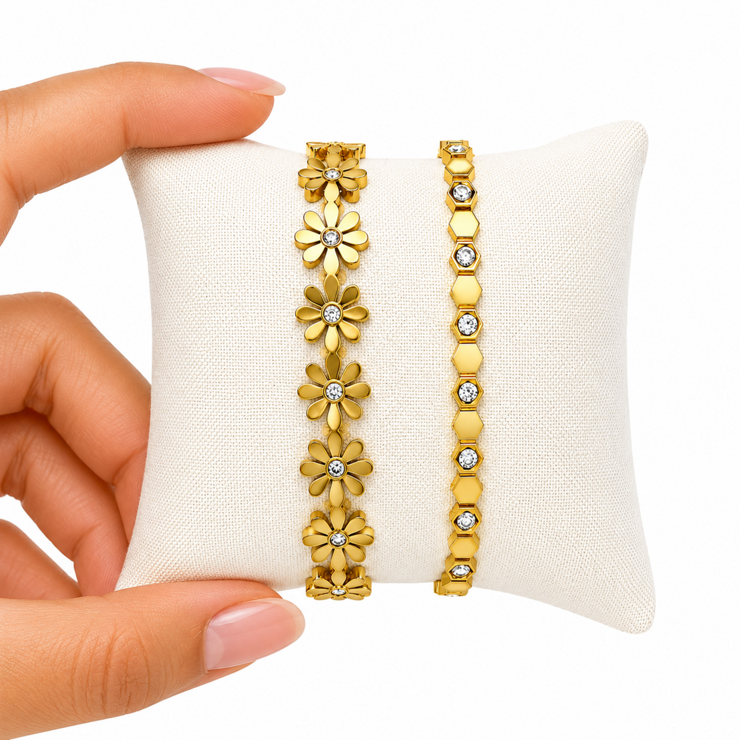 A close-view of a premium two-piece gold-plated structural bracelet stack for women featuring a geometric crystal honeycomb bangle and a polished gold floral station bangle