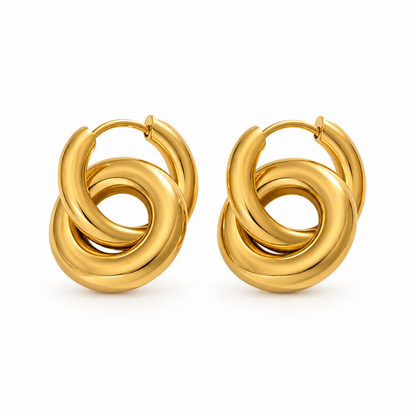 A pair of gold huggie hoop earrings with a thick, polished knot-like twist design, shown on a clean white background.
