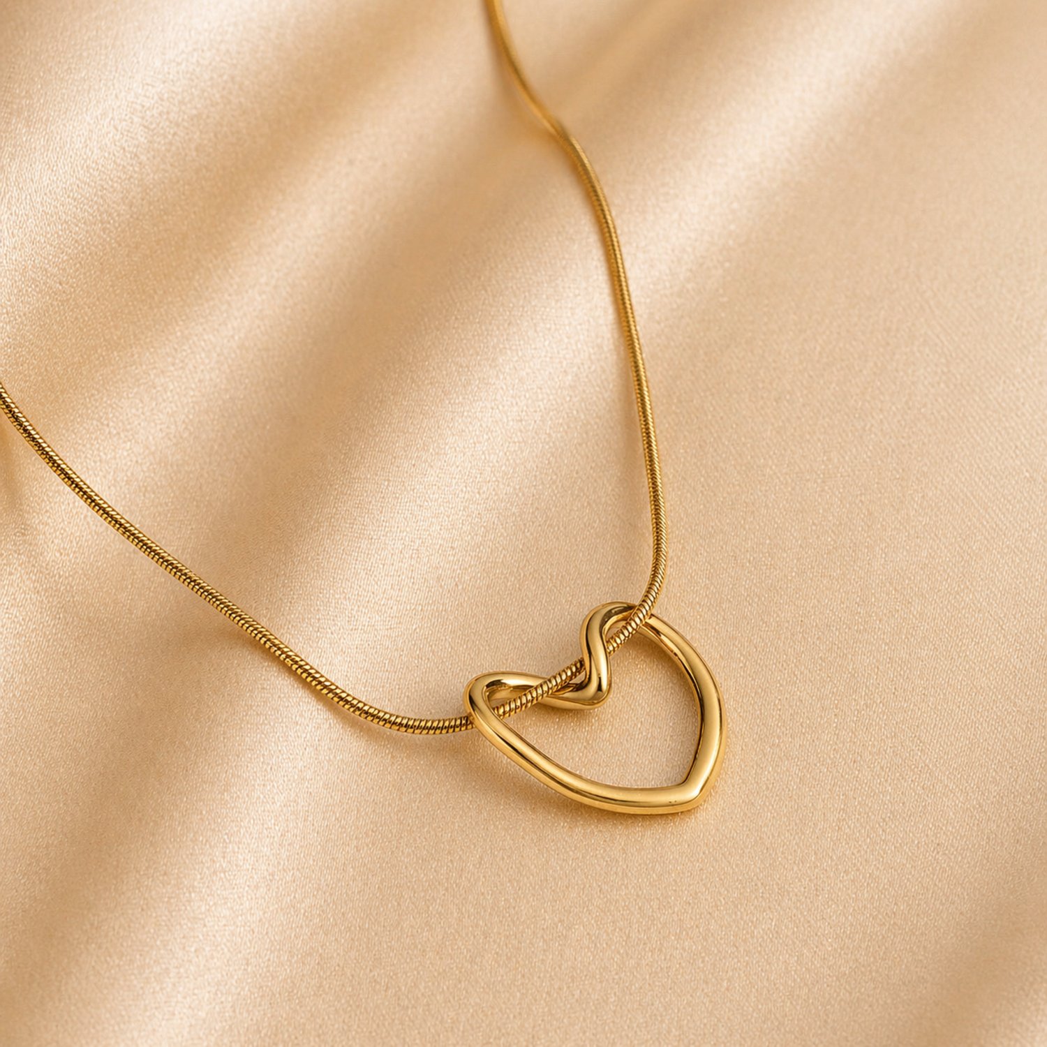 A gold-plated stainless steel chain for women featuring open-heart pendant intertwined with a sleek chain