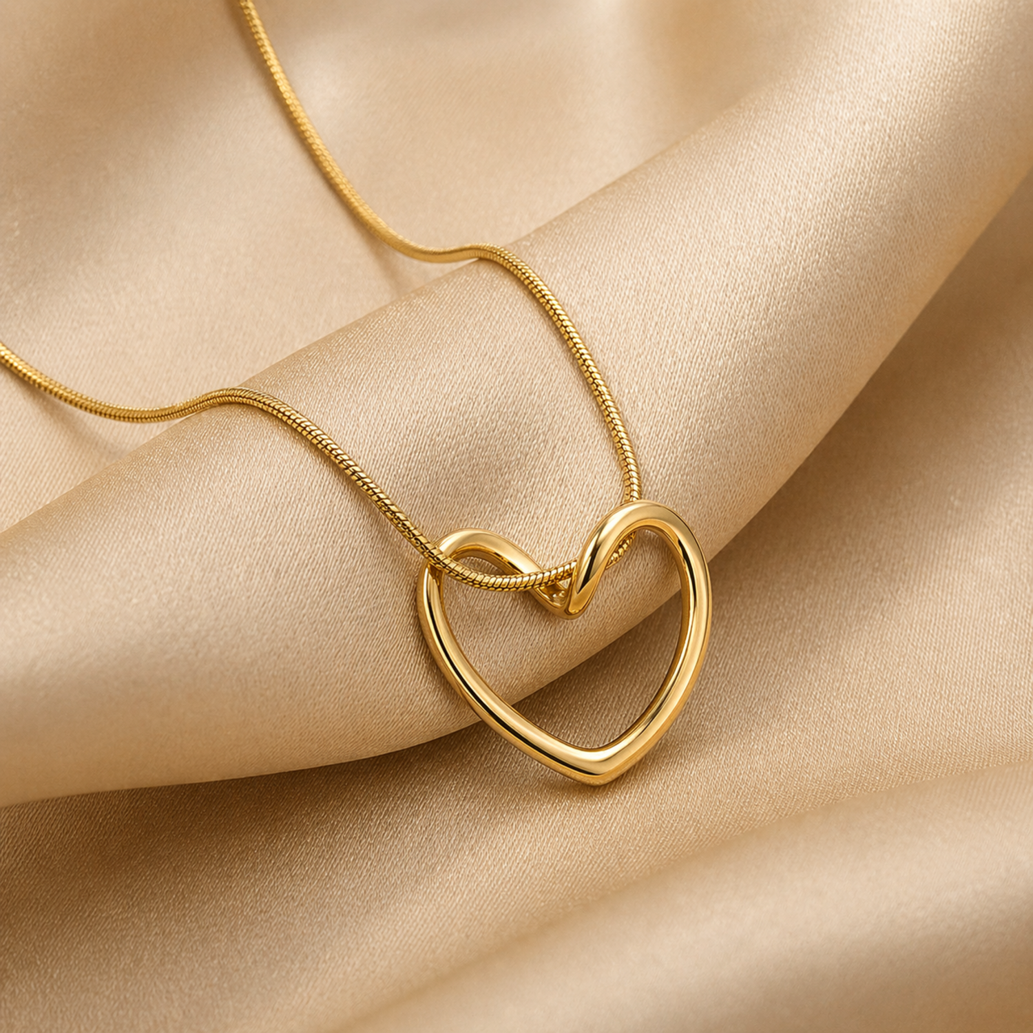 A close-view of a gold-plated stainless steel chain for women featuring open-heart pendant intertwined with a sleek chain