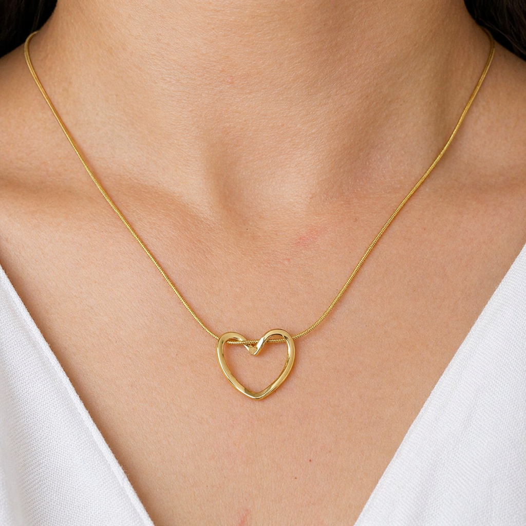 A gold-plated stainless steel chain for women featuring open-heart pendant intertwined with a sleek chain shown on a model