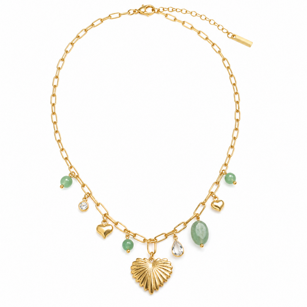 A gold-plated stainless steel chain for women featuring paperclip links and a variety of charms including a textured gold heart, green beads, and crystal accents.