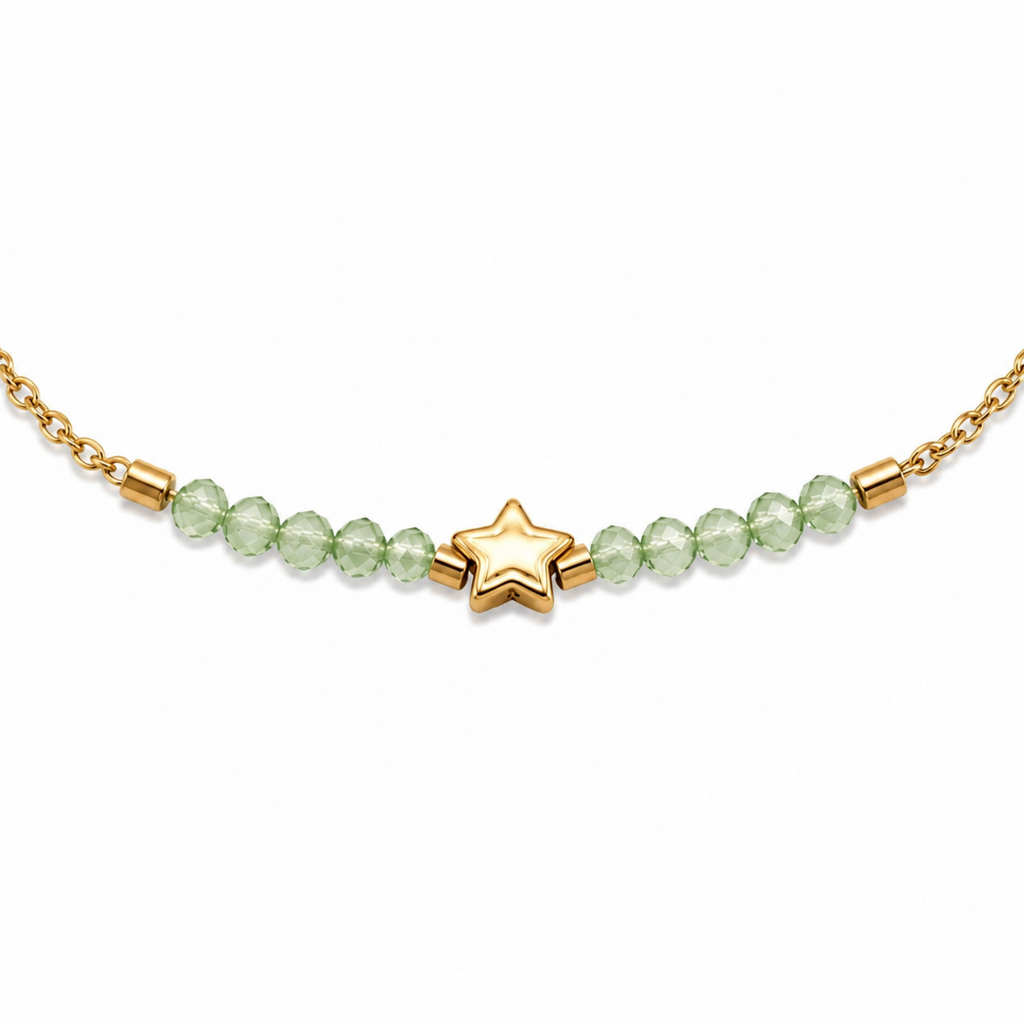 A close-view of a delicate gold-plated stainless steel chain bracelet for women featuring pale-green faceted jadeite beads and a central gold star charm.