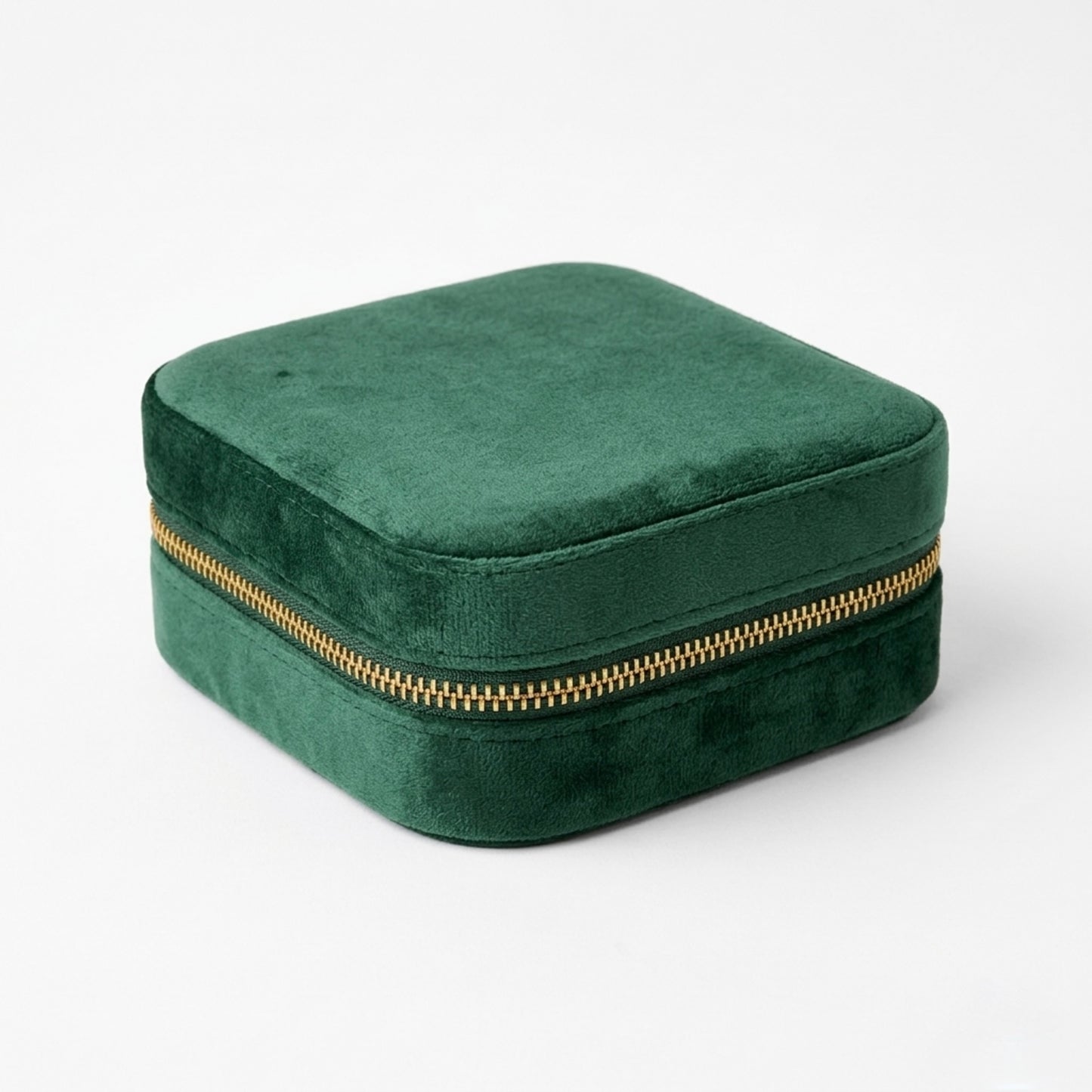 Emerald Green velvet jewelry box with a gold zipper on a white background