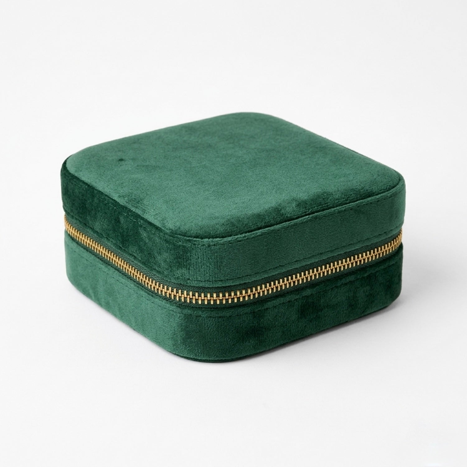 Emerald Green velvet jewelry box with a gold zipper on a white background