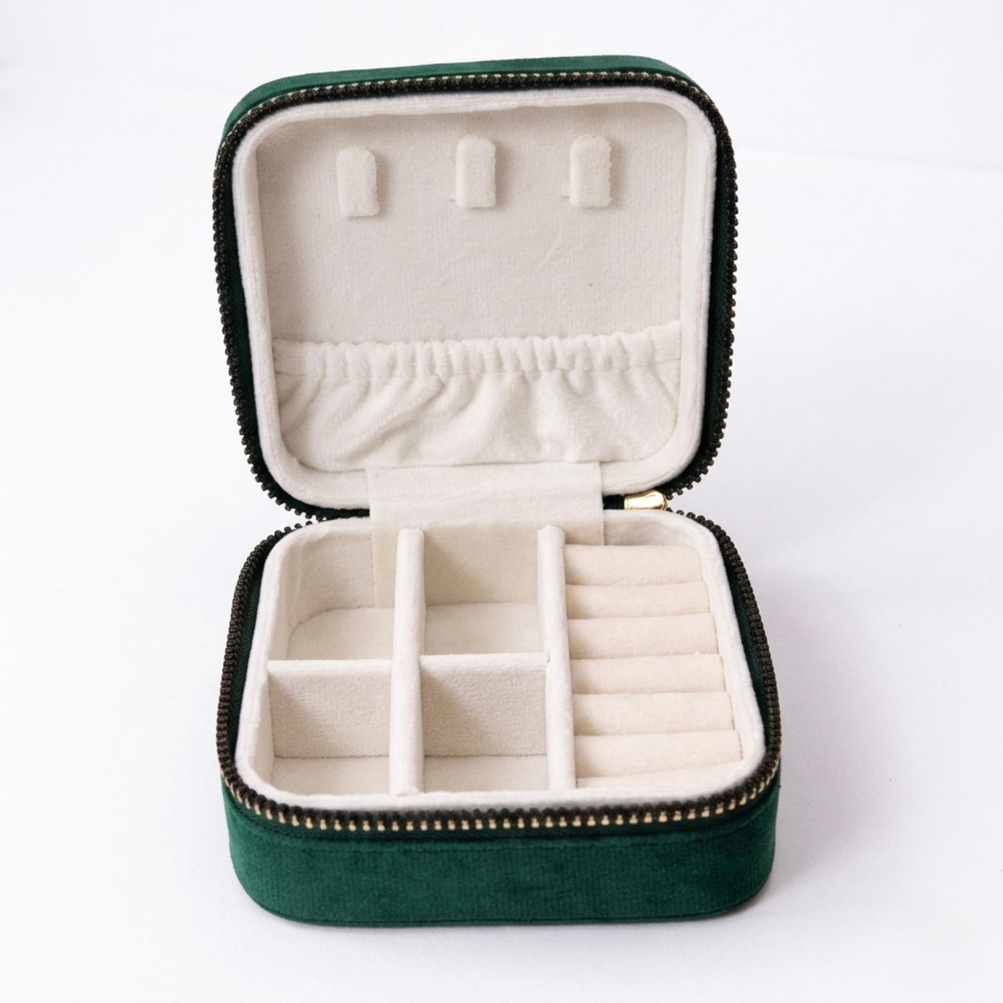 open velvet travel size jewellery box organizer in emerald green showing compartments inside