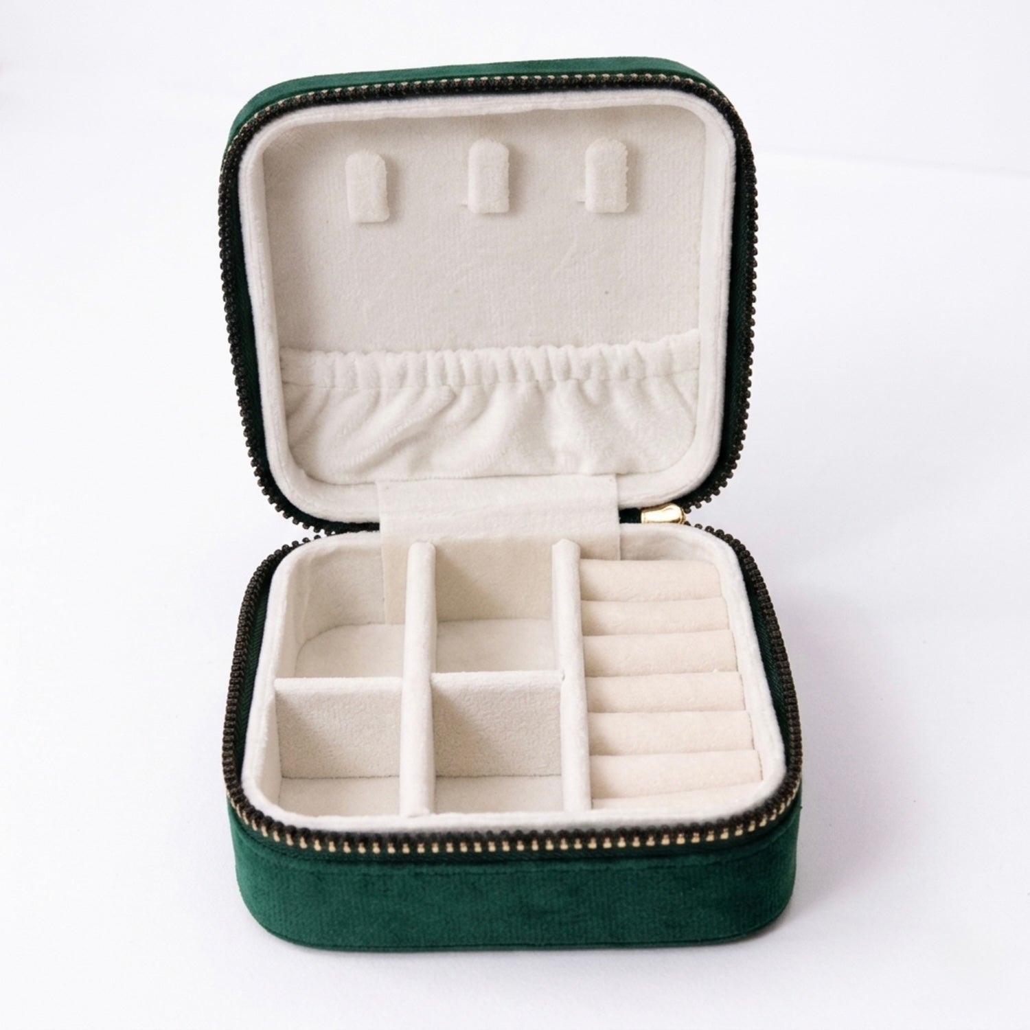 open velvet travel size jewellery box organizer in emerald green showing compartments inside