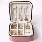 open velvet travel size jewellery box organizer in mauve showing compartments inside