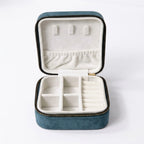 open velvet travel size jewellery box organizer in teal blue showing compartments inside