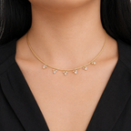 A gold-plated stainless steel chain for women featuring a twisted cord design with six dangling marquise-cut crystal floral charms, shown on a model