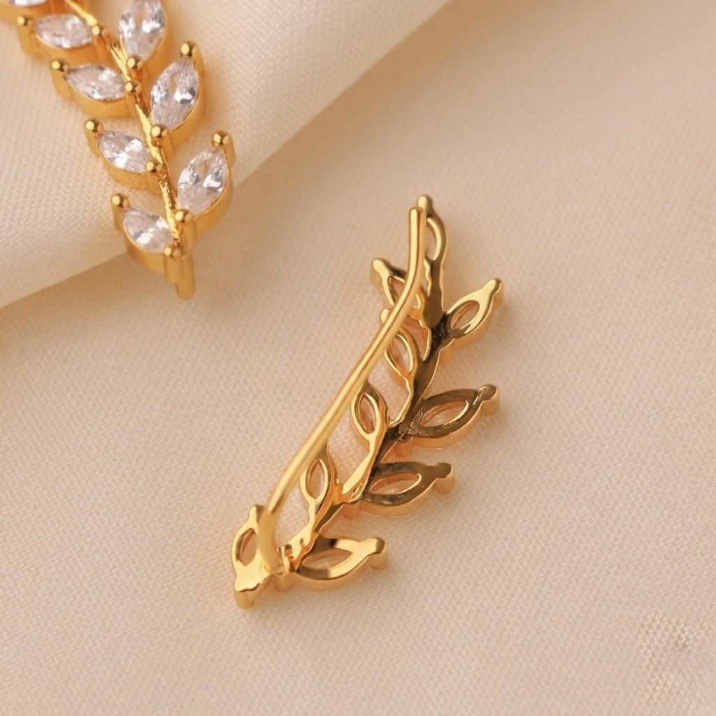 Back view of a gold-plated laurel vine ear climber earring for women featuring sparkling marquise-cut white leaves on a beige background