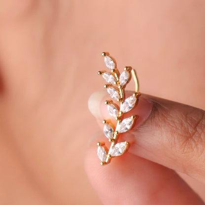 A close-view of a gold-plated laurel vine ear climber earrings for women featuring sparkling marquise-cut white leaves