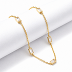 A gold-plated stainless steel chain for women featuring five bezel-set baguette-cut crystal stations