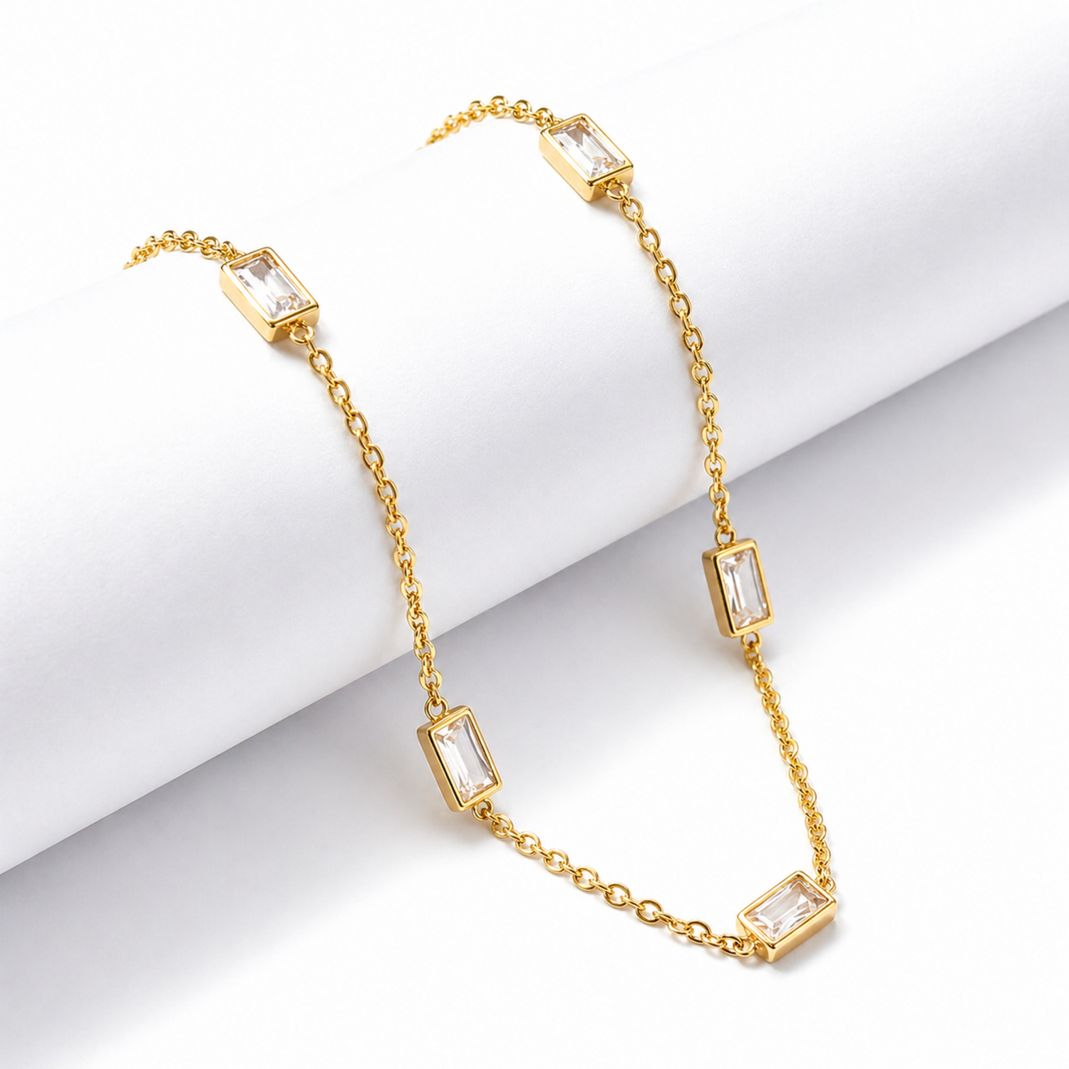 A gold-plated stainless steel chain for women featuring five bezel-set baguette-cut crystal stations