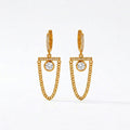 A pair of gold-plated long earrings for women featuring a hoop, a horizontal crystal bar, and a dangling gold curb chain loop, shown on a white background.
