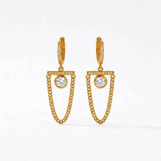 A pair of gold-plated long earrings for women featuring a hoop, a horizontal crystal bar, and a dangling gold curb chain loop, shown on a white background.