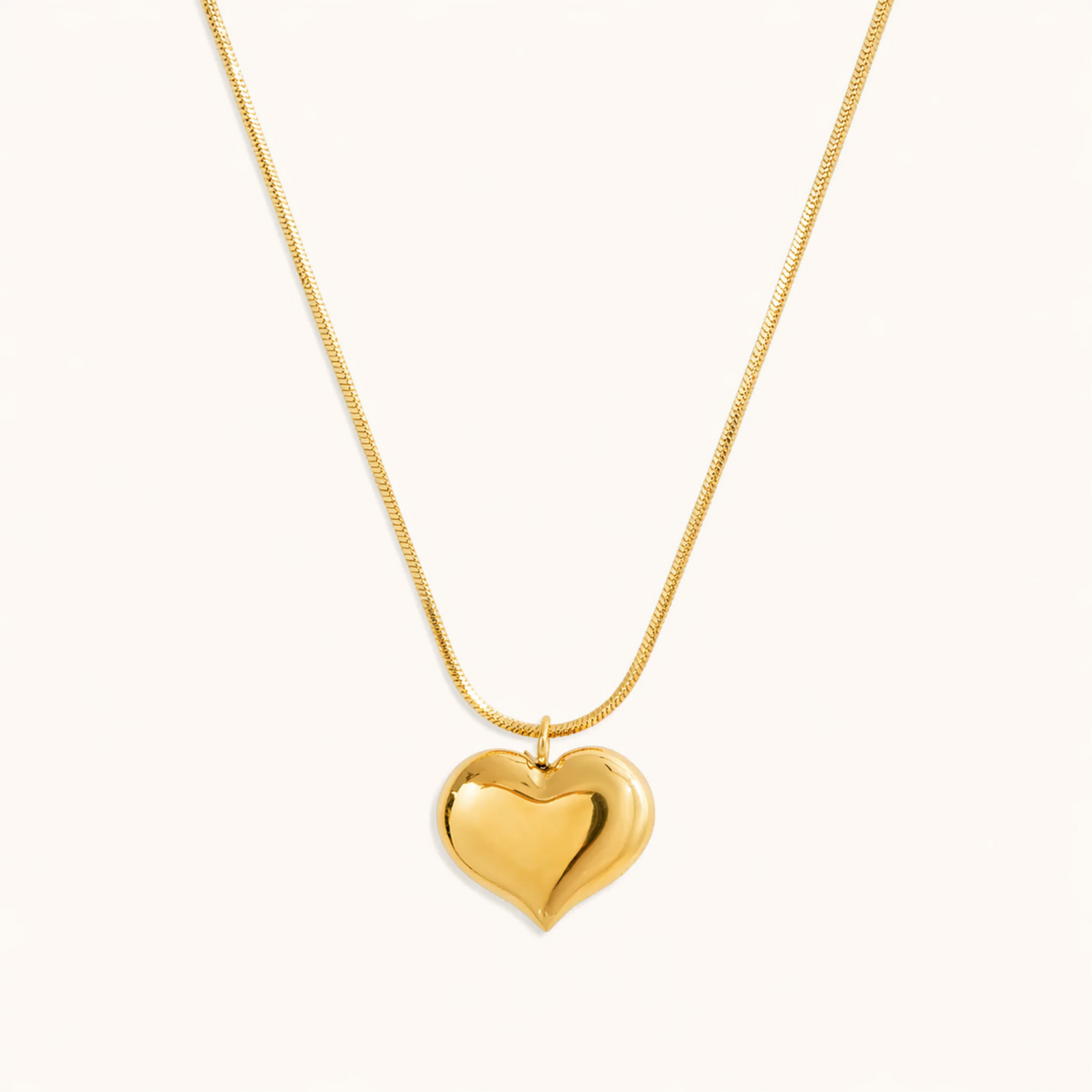 A gold-plated stainless steel chain for women featuring a small, polished 3D puffed heart pendant on a delicate link chain