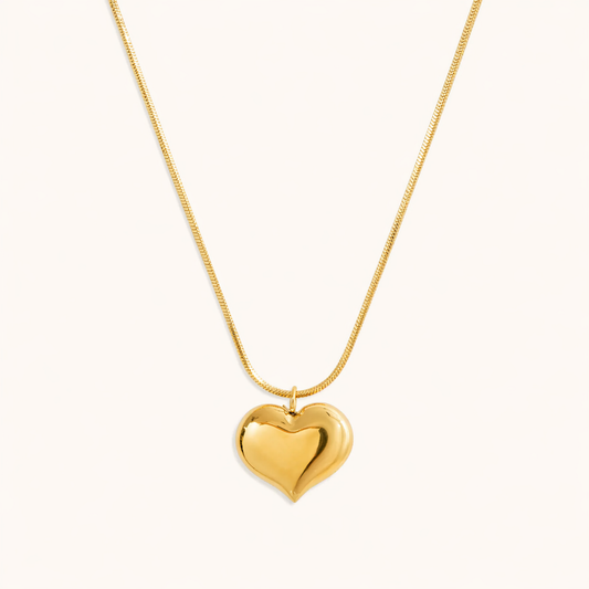 A gold-plated stainless steel chain for women featuring a small, polished 3D puffed heart pendant on a delicate link chain