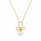A gold-plated stainless steel chain for women featuring a crystal-encrusted bow pendant with a large white pearl drop, isolated on a white background