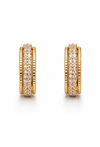 A pair of gold-plated textured hoop earrings for women featuring a central row of clear crystals and ridged outer bands, on a white background