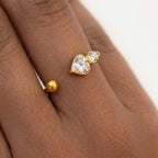 closeup view of a dainty 18kt gold plated stainless steel adjustable ring for women featuring three small clear white stones and a gold bead