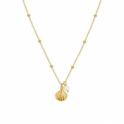 Gold necklace with a shell and pearl pendant on a white background