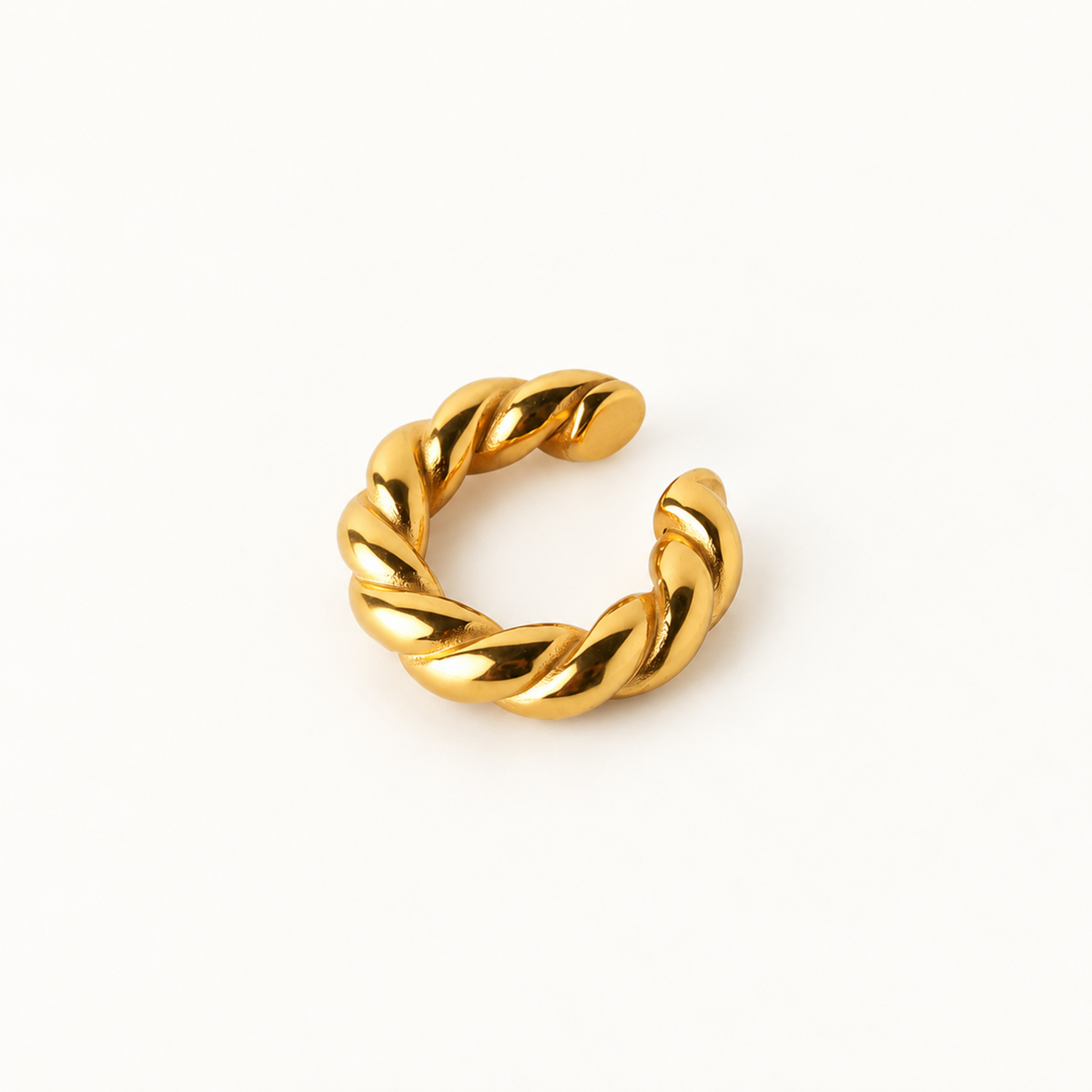 A gold twisted open ear cuff, photographed on a clean white background.