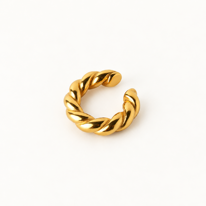 A gold twisted open ear cuff, photographed on a clean white background.