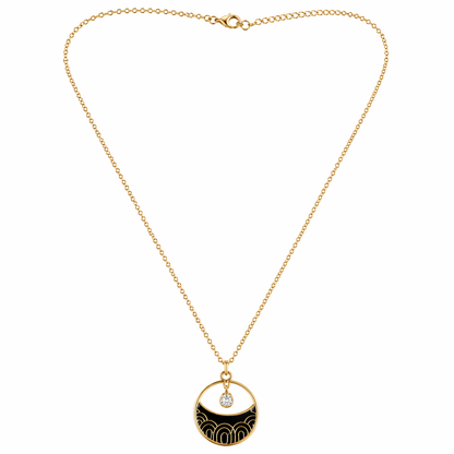 A gold-plated stainless steel chain for women featuring a circular pendant with black enamel wave patterns and a single floating crystal.