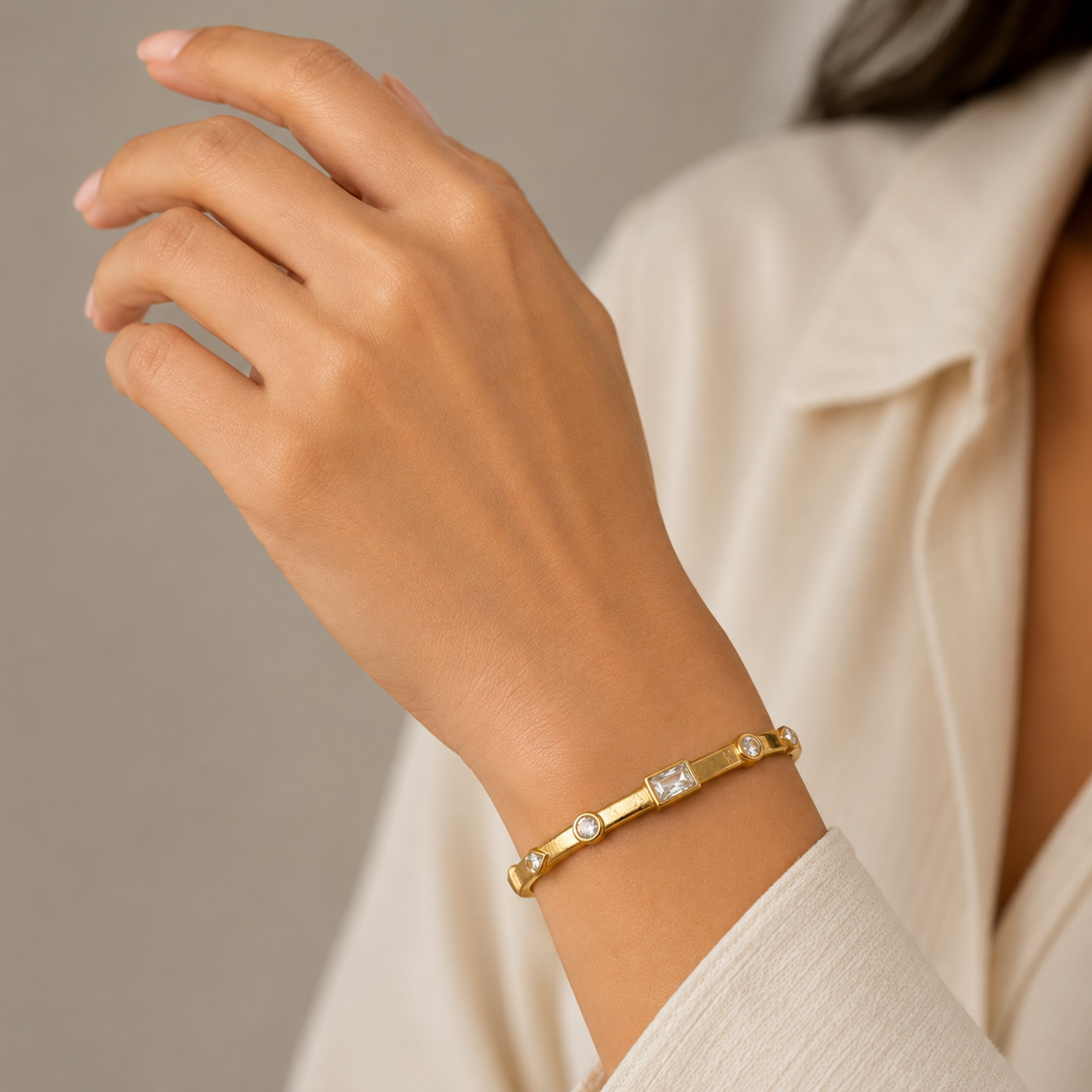 A gold-plated bracelet for women featuring crystal inlays, organic textures, and modern geometric designs.