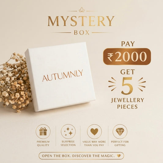 Promotional graphic for an Autumnly Mystery Box offering, a ₹2000 deal for 18 jewellery pieces, complete with feature icons at the bottom.
