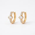 A pair of gold-plated huggie hoop earrings for women featuring a central kite-set princess-cut clear crystal, shown on a clean white background.