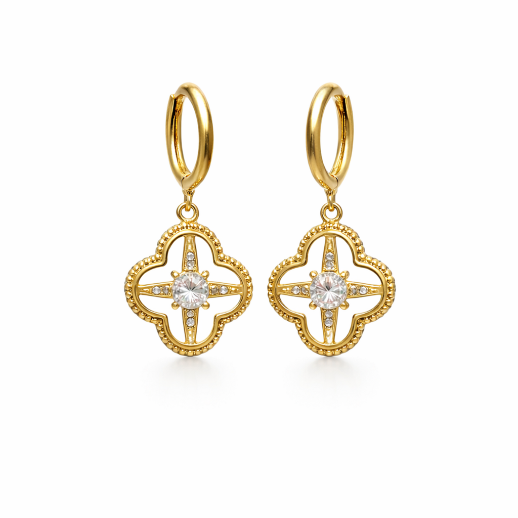 A pair of gold-plated hoop earrings for women featuring a dangling clover-shaped lattice charm with a central crystal stone, shown on a white background.