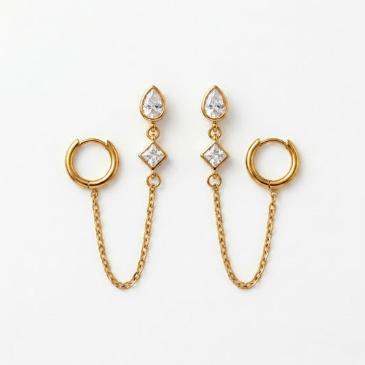 A pair of gold-plated ear chain earrings for women connecting a tiered crystal drop stud to a small gold hoop with a fine chain.