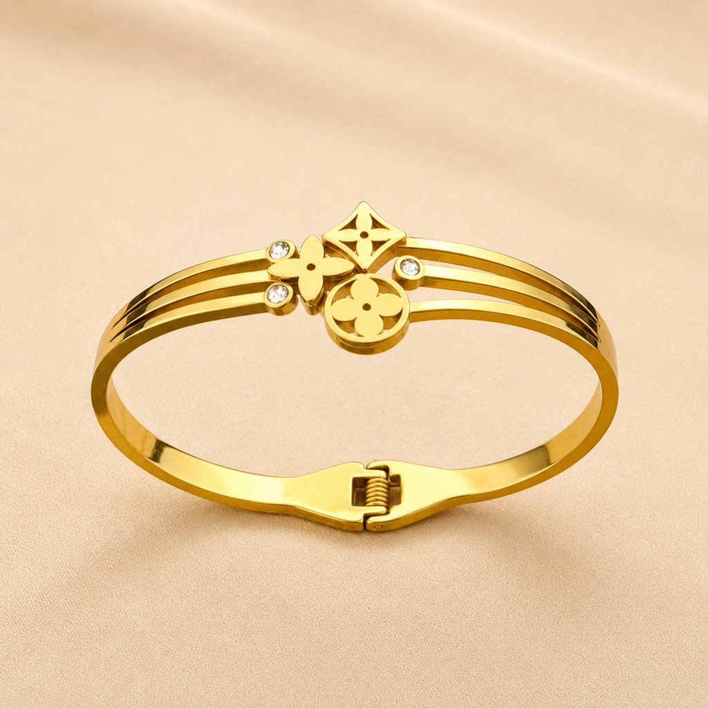A close-view of a gold-plated celestial cuff bangle for women featuring crystal-encrusted moon and star motifs with an openwork design