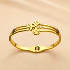 A close-view of a gold-plated celestial cuff bangle for women featuring crystal-encrusted moon and star motifs with an openwork design
