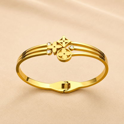 A close-view of a gold-plated celestial cuff bangle for women featuring crystal-encrusted moon and star motifs with an openwork design