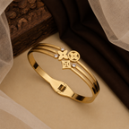 A gold-plated celestial cuff bangle for women featuring crystal-encrusted moon and star motifs with an openwork design
