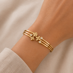 A gold-plated celestial cuff bangle for women featuring crystal-encrusted moon and star motifs with an openwork design, shown on a model