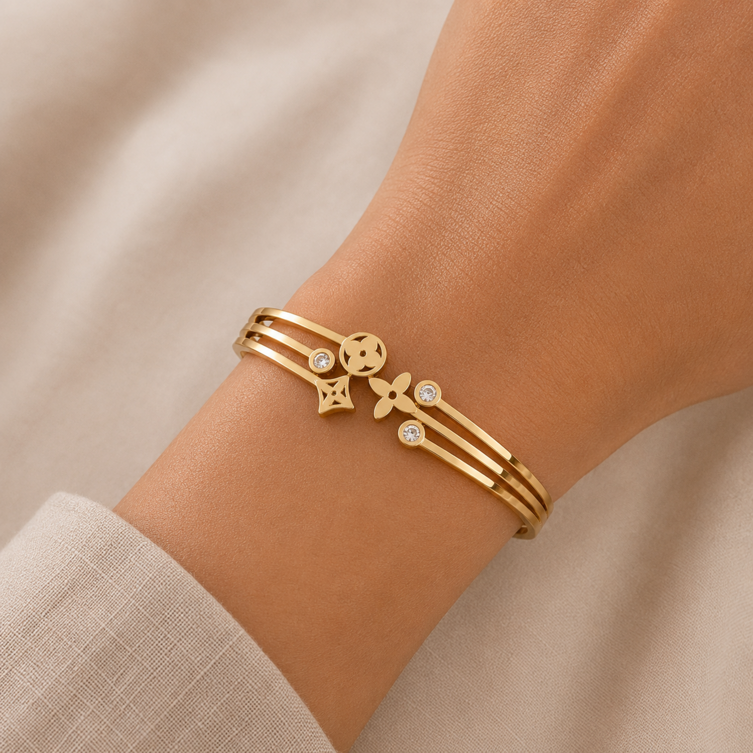 A gold-plated celestial cuff bangle for women featuring crystal-encrusted moon and star motifs with an openwork design, shown on a model